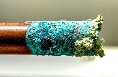 Corrosion build up on copper pipes due to acidic water in maryland